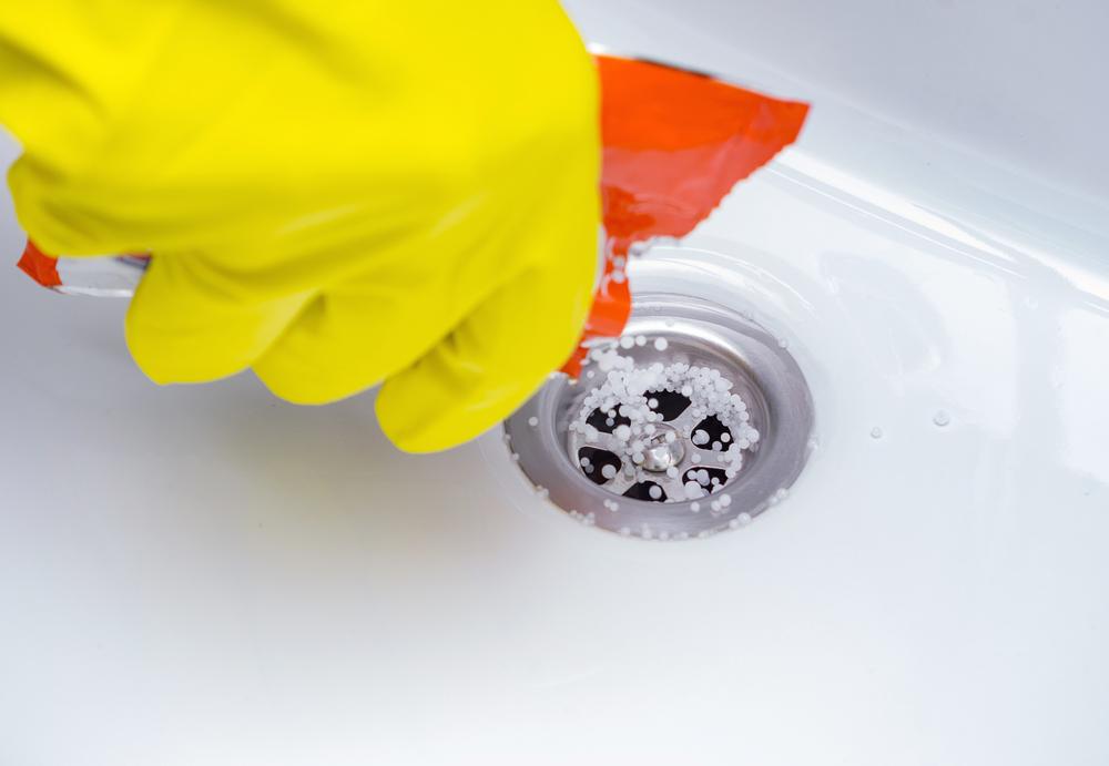 The Drain Cleaner Granules In Sink. Cleaning The Plughole Of a Sink Drain