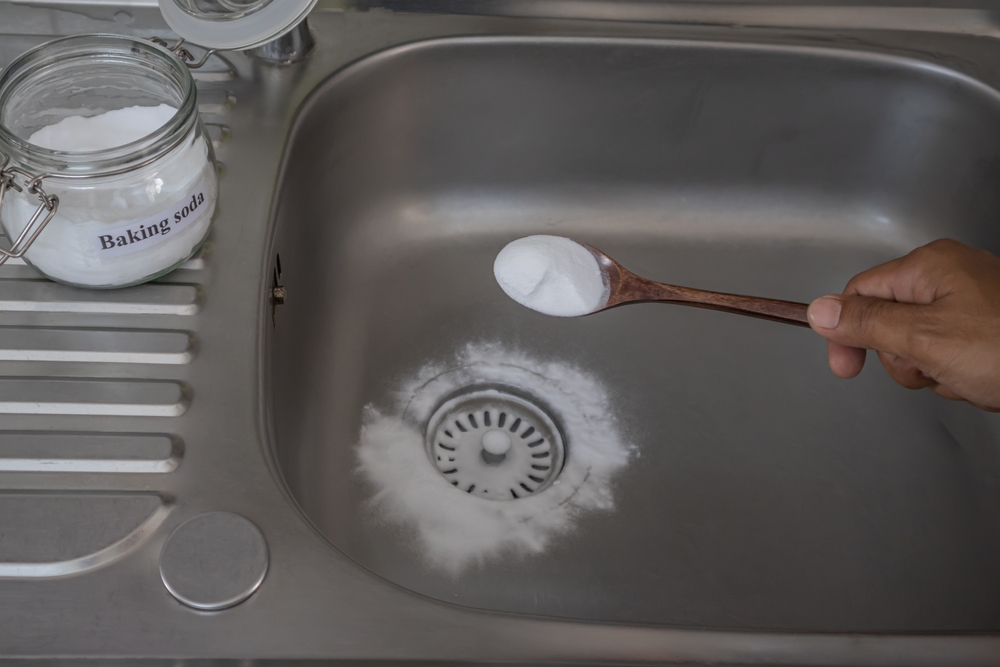 Man Pouring Baking Soda To Clear Clogs In Sinks